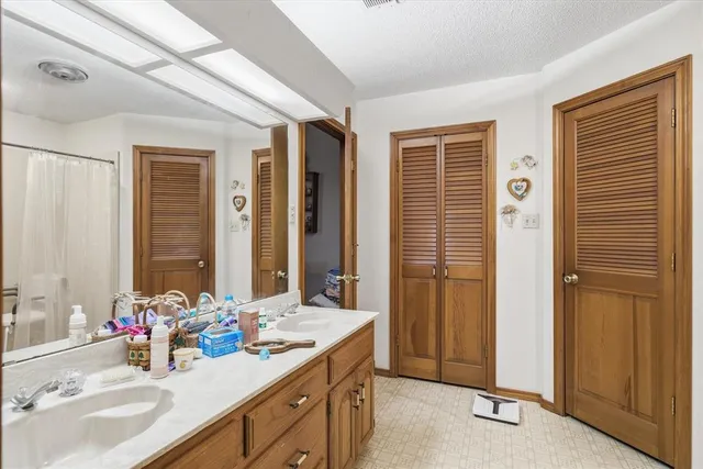 a bathroom with a double vanity sink and a mirror