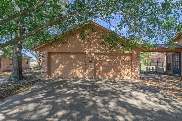 a backyard of a house with large trees and outdoor seating
