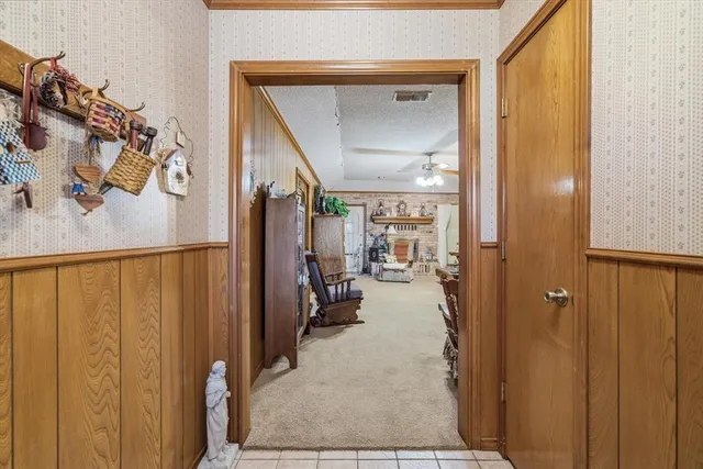 a view of a hallway with closet and a white door