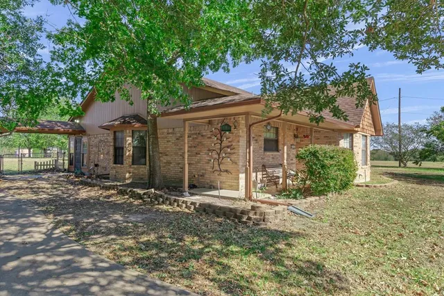 front view of a house with a tree in the yard