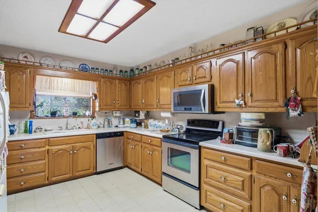 a kitchen with a sink stove and microwave