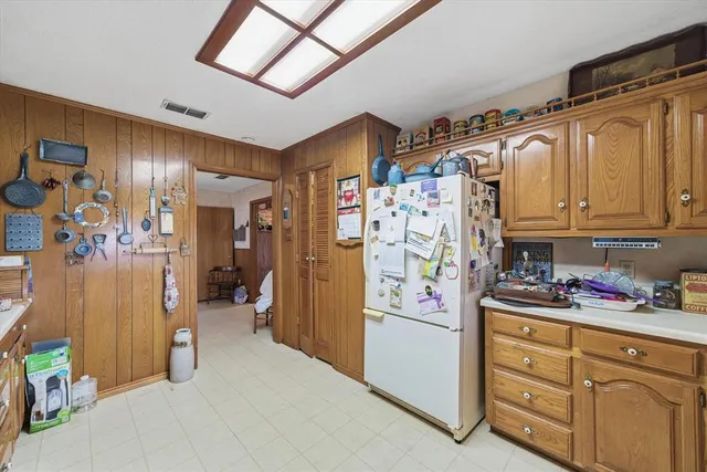 a kitchen with stainless steel appliances a refrigerator and cabinets