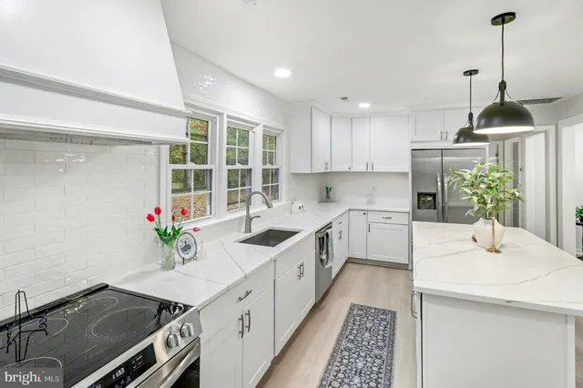 a kitchen with a sink stove and cabinets