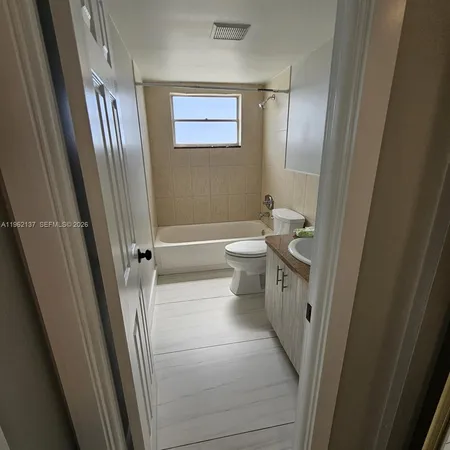 a bathroom with a toilet a sink and a mirror