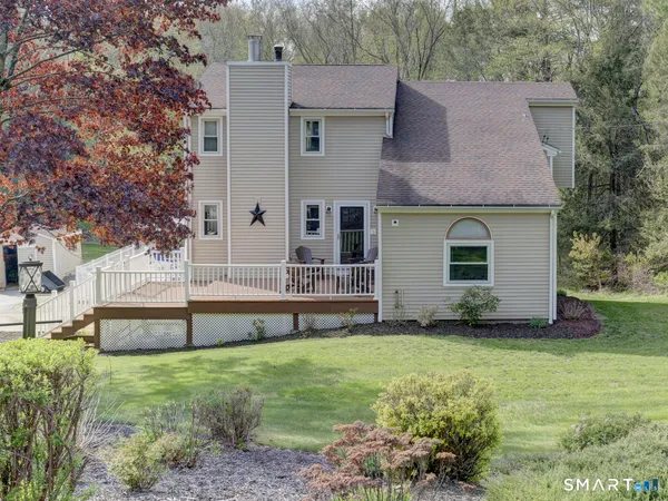 a view of a house with a yard and sitting area