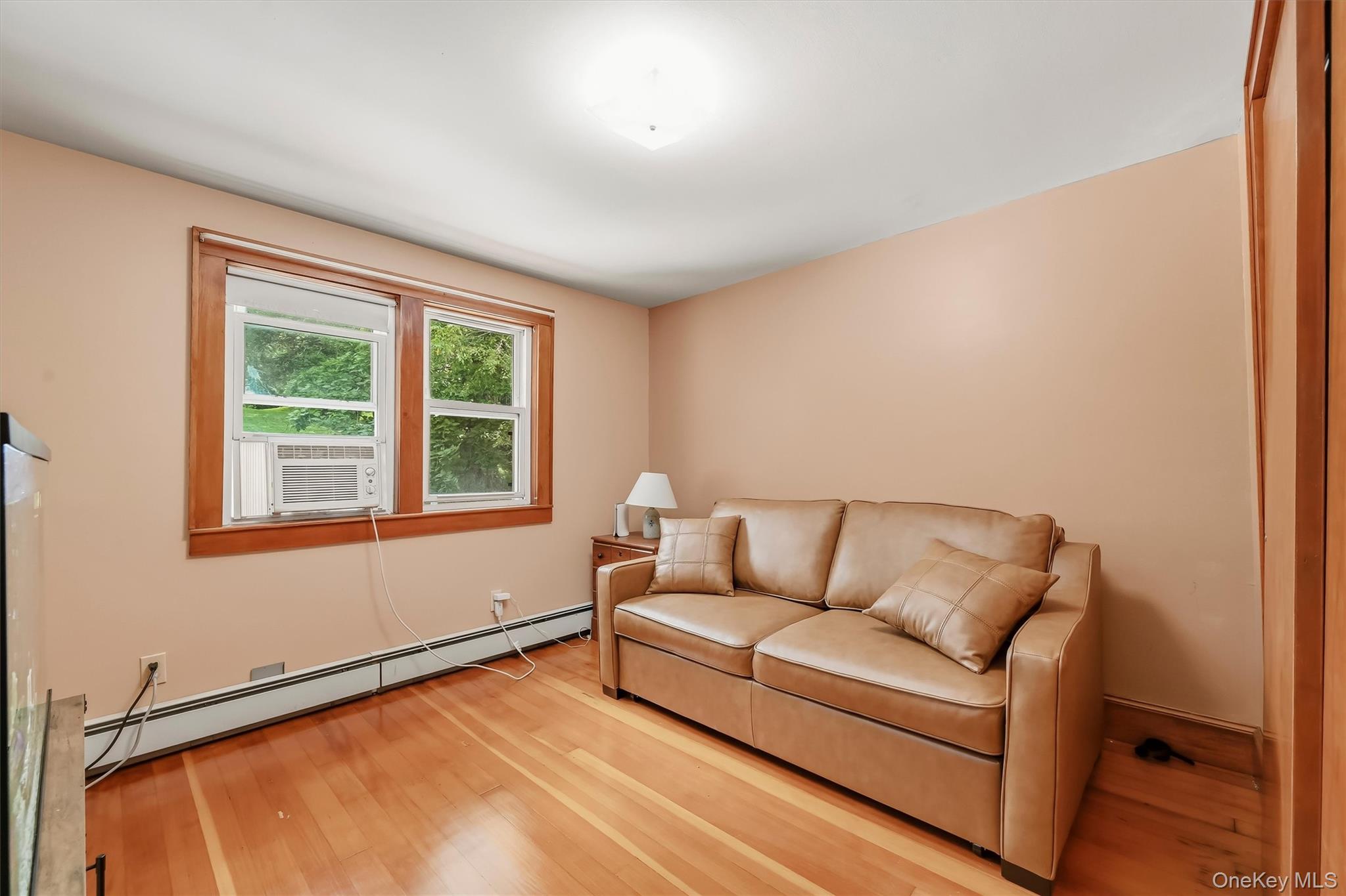 328 Big Island Road Florida, NY 10921 - Photo 19 of 40 Bedroom with hardwood floors, wood trim and ample natural light.