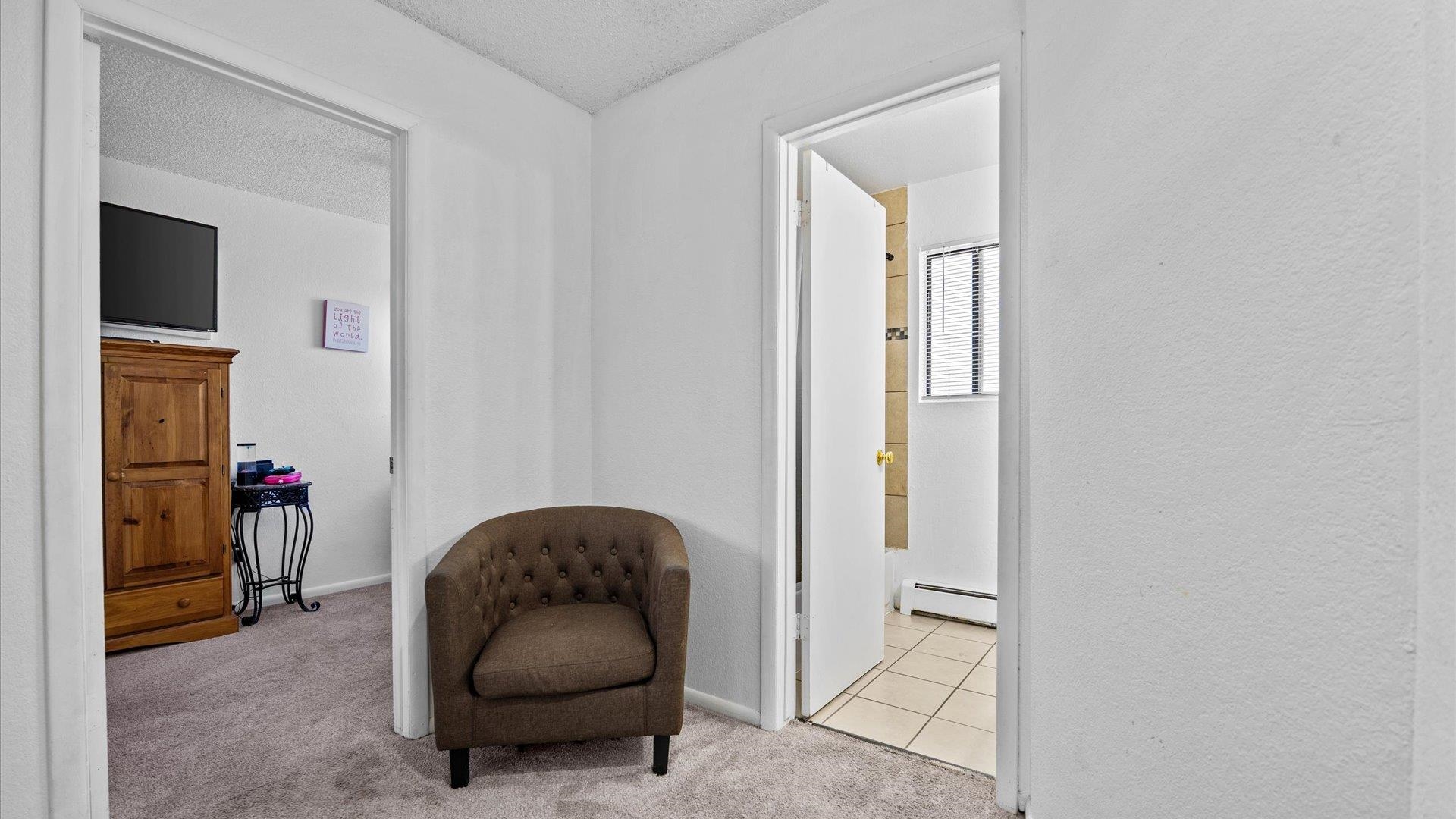 510 Coronado Court, Unit R Clifton, CO 81520 - Photo 11 of 20 a living room with furniture and a mirror