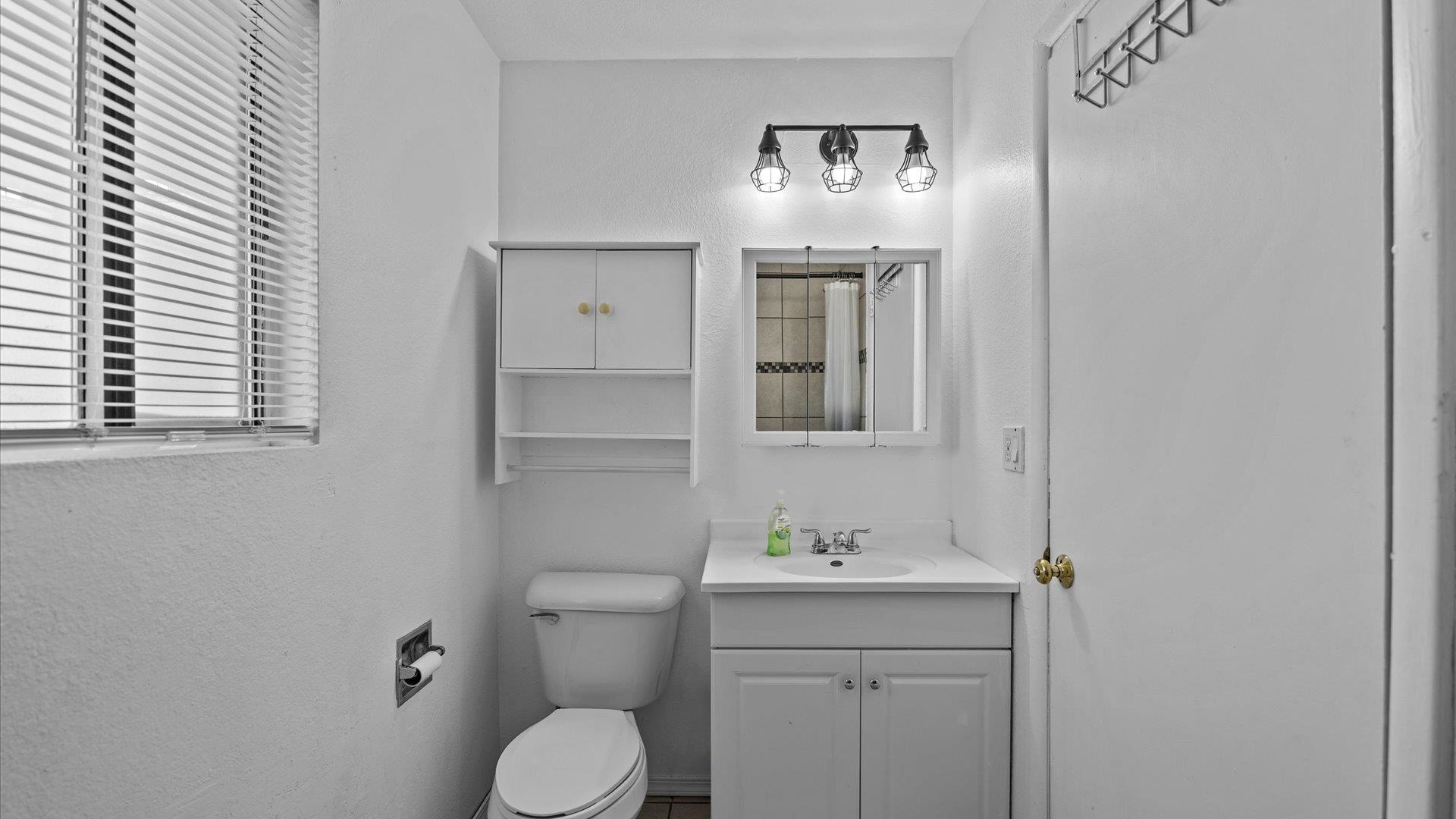 510 Coronado Court, Unit R Clifton, CO 81520 - Photo 17 of 20 a bathroom with a toilet sink and mirror