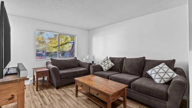 a living room with furniture and a large window