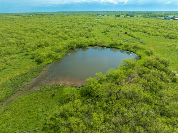 a view of a lake with a yard