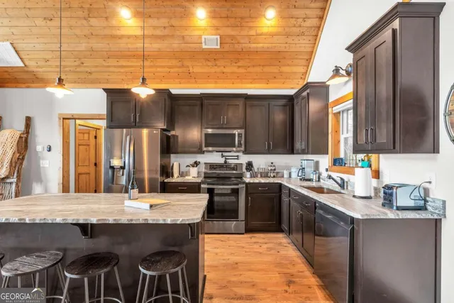 a kitchen with granite countertop a sink and a counter top space