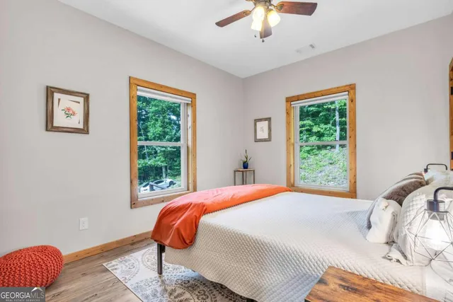 a view of a hallway with wooden floor and stairs