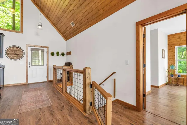a living room with furniture rug and wooden floor