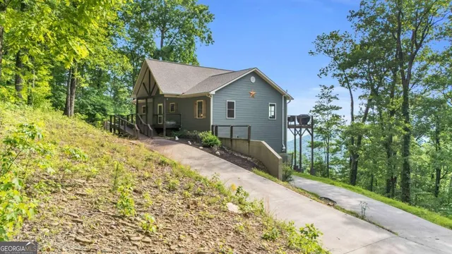 a view of a backyard with wooden fence