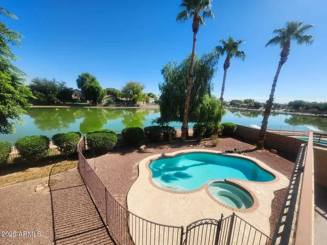 a view of a lake with a table and chairs