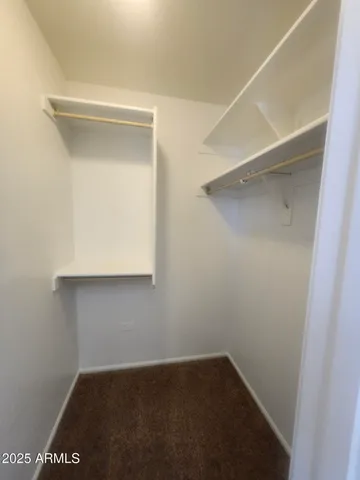 a view of a hallway with wooden floor and stairs