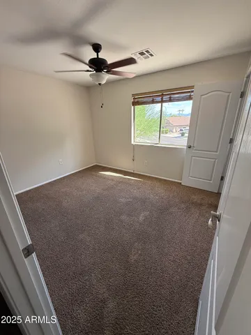 a view of an empty room with a ceiling fan