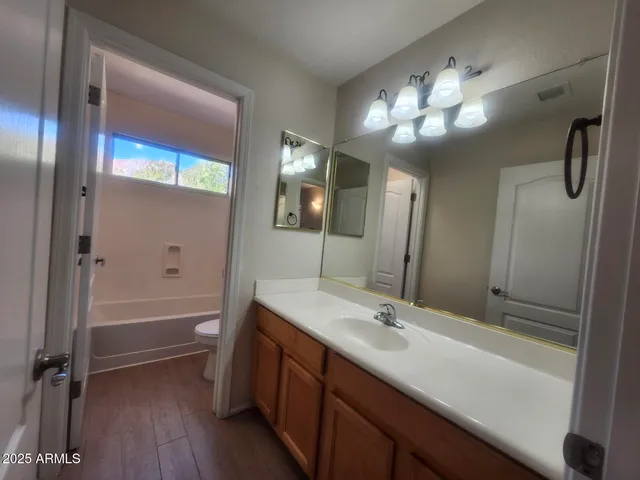 a bathroom with a tub and a toilet