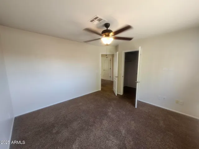 a view of a small space with wooden floor and a window