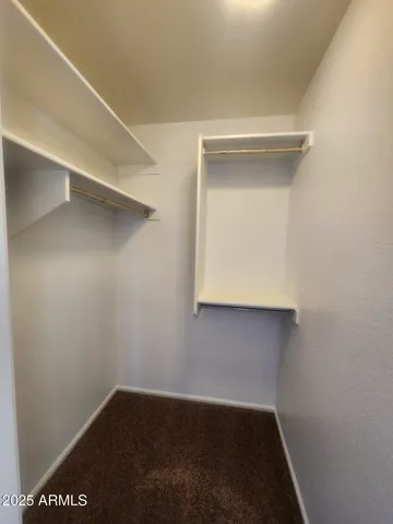 en empty room with windows and ceiling fan