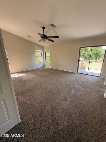 a view of a room with a ceiling fan