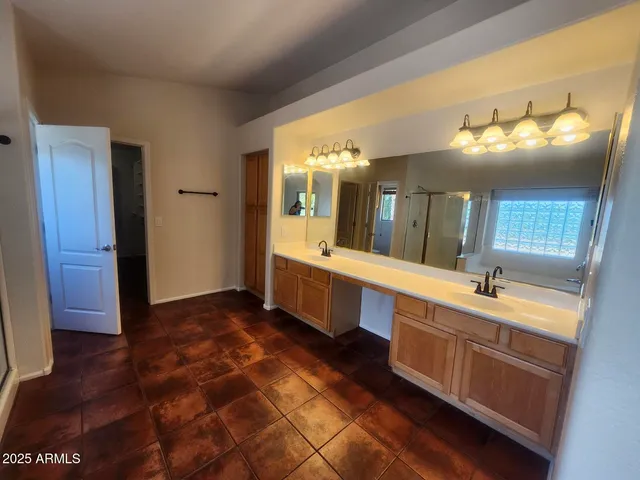 a bathroom with a tub a sink and a shower