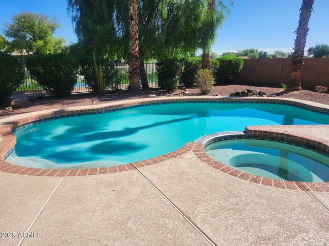a view of a hallway with wooden floor and a window
