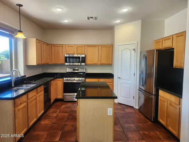 a view of a living room a dining room wooden floor and a window