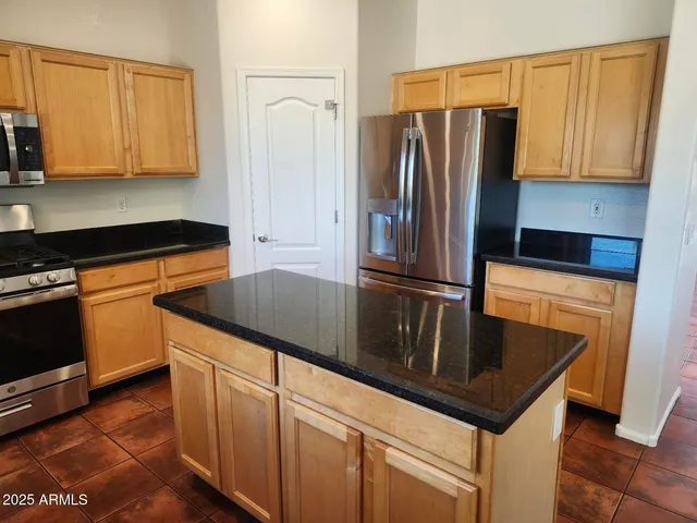 a kitchen with granite countertop cabinets stainless steel appliances and a sink