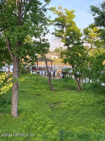 a view of a house with backyard porch and sitting area