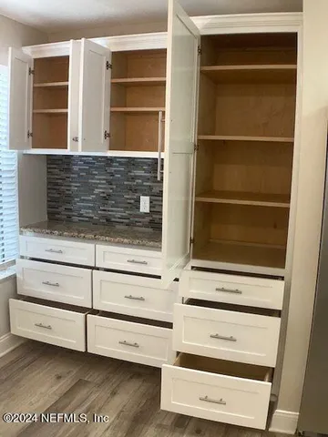 a view of a swimming pool with outdoor seating and plants