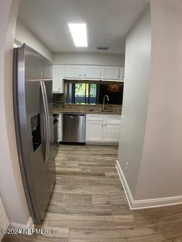 a stove top oven sitting inside of a kitchen