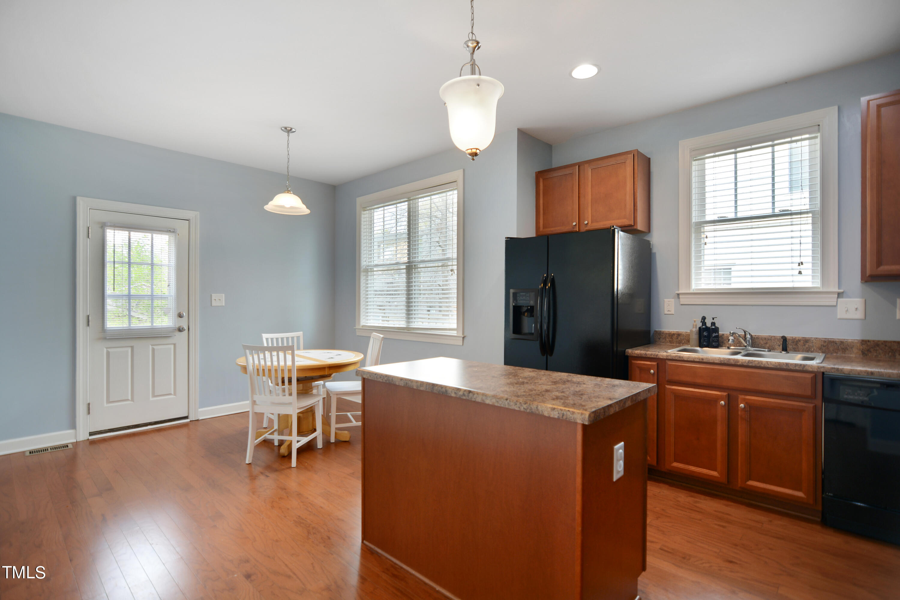 207 Idlewild Avenue Raleigh, NC 27601 - Photo 4 of 14 a kitchen with granite countertop a sink a counter space dining table and stainless steel appliances