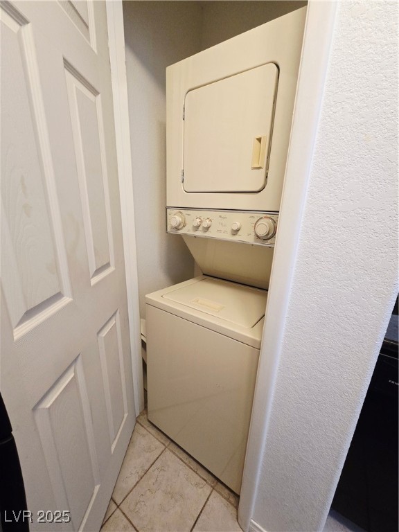 5211 South Lindell Road, Unit 104 Las Vegas, NV 89118 - Photo 6 of 12 Laundry room with light tile patterned flooring and stacked washing machine and dryer