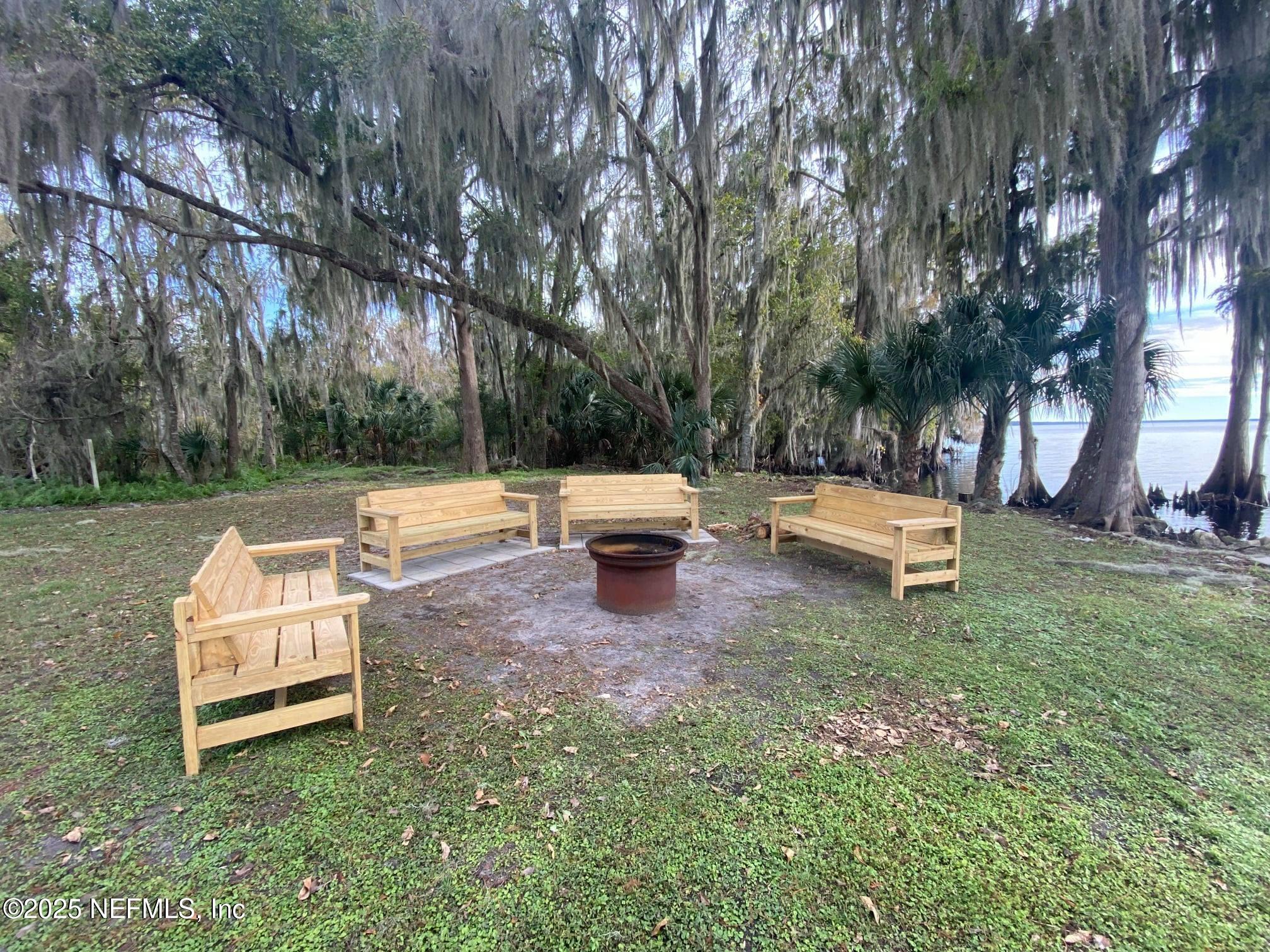 806 Paradise Boulevard Georgetown, FL 32139 - Photo 12 of 16 a wooden bench sitting in the middle of a yard