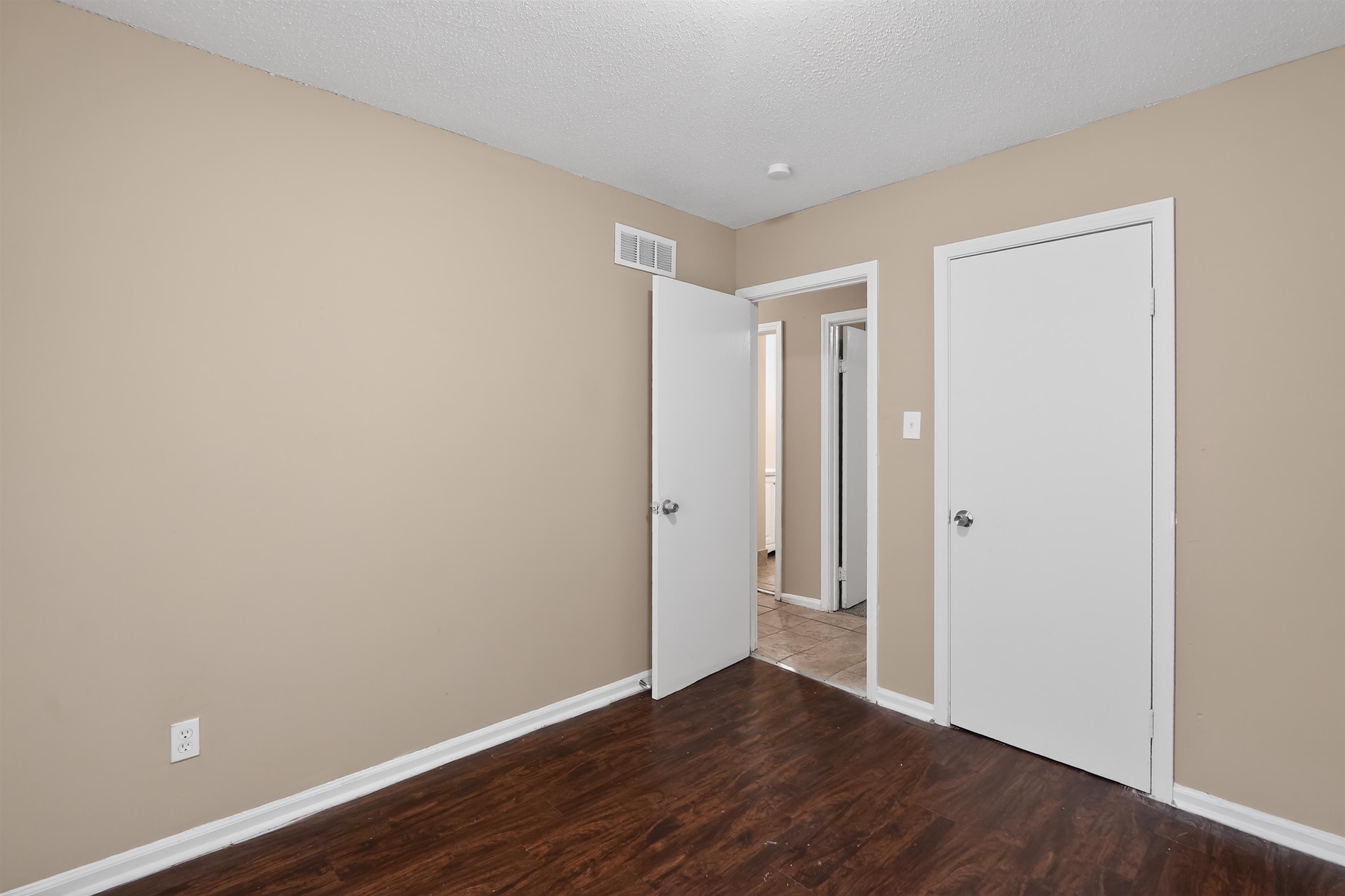 3608 Cane Ridge Drive Memphis, TN 38109 - Photo 23 of 31 Room featuring wood-finish flooring, neutral wall tones, and white trim