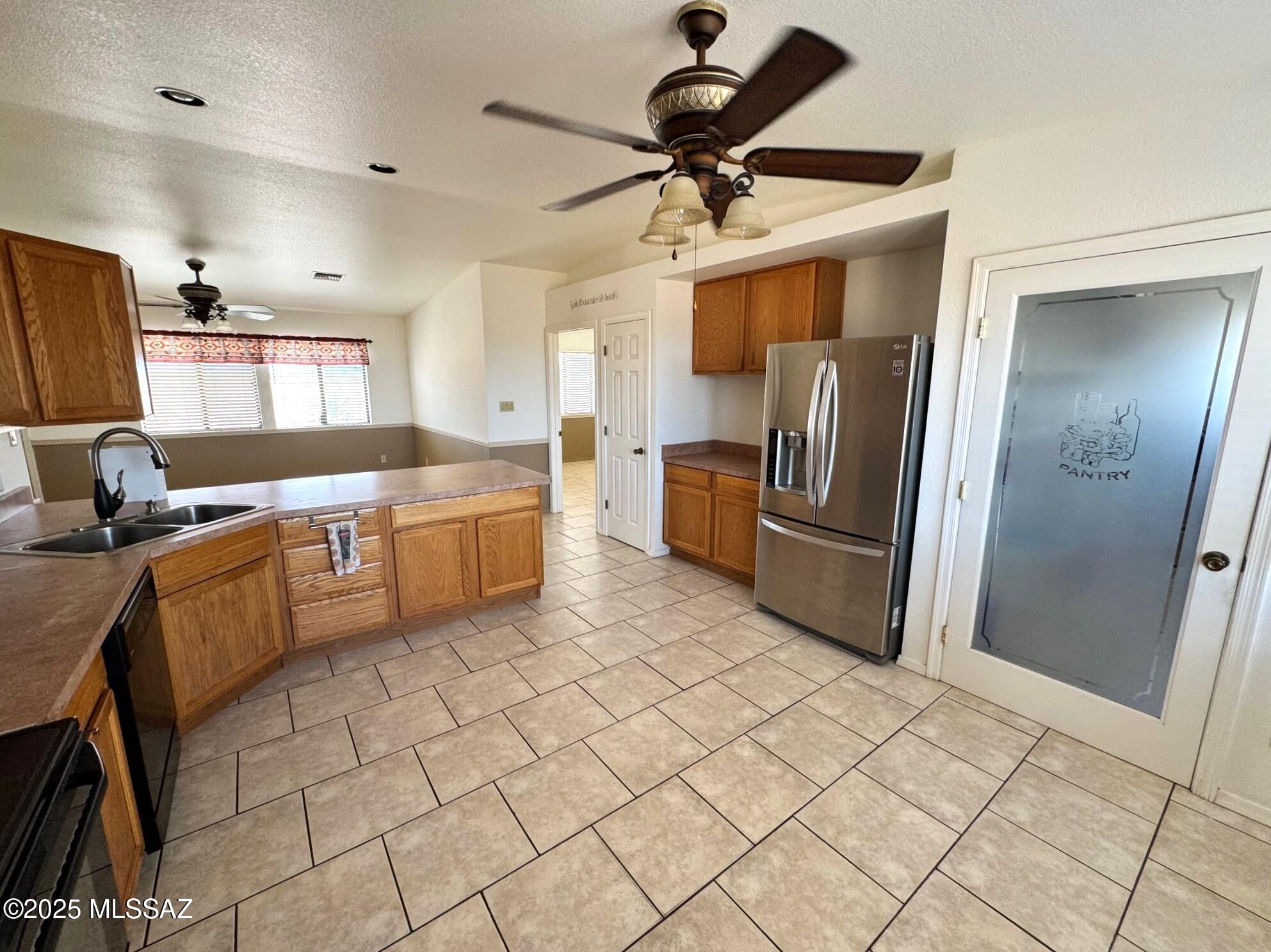 13384 South Cottonwood Road Pearce, AZ 85625 - Photo 11 of 46 a kitchen with stainless steel appliances a refrigerator sink and microwave