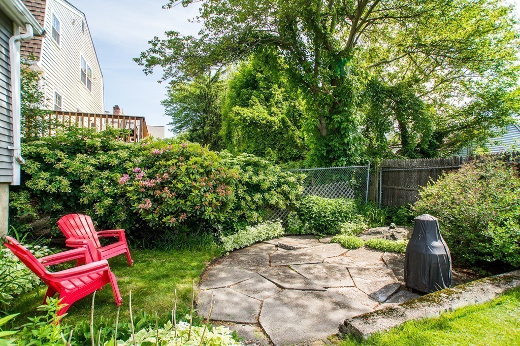 69 Lakeview Terrace Waltham, MA 02451 - Photo 16 of 17 a backyard of a house with lots of green space and plants