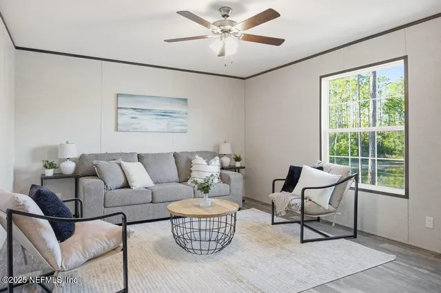 a living room with furniture and a large window