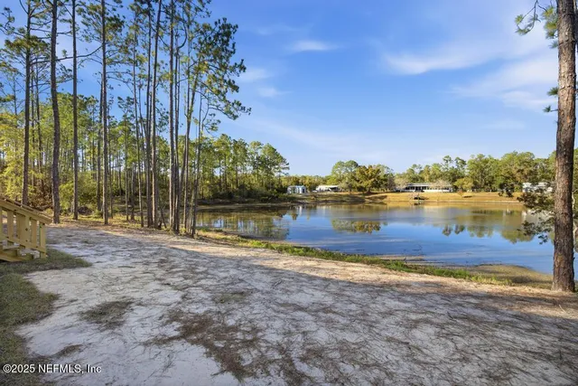 a view of a lake with houses in the back