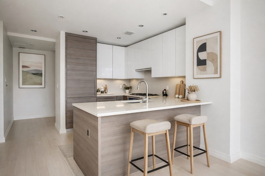 1 Franklin Street, Unit 1714 Boston, MA 02110 - Photo 4 of 10 a kitchen with a sink cabinets and window