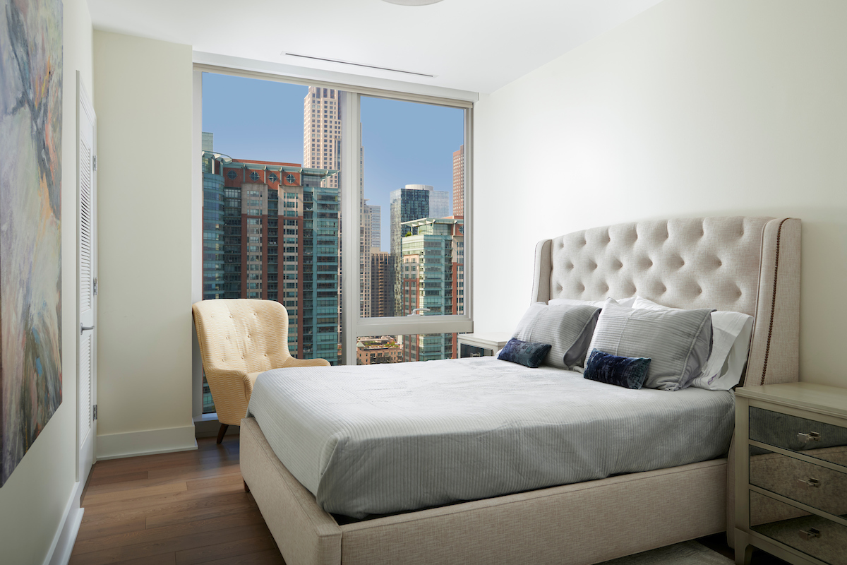 363 East Wacker Drive, Unit 1506 Chicago, IL 60601 - Photo 21 of 34 a bedroom with a bed and wooden floor