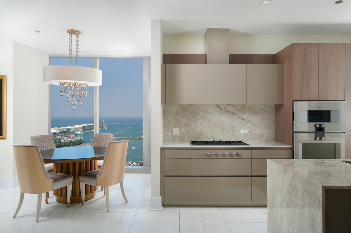 363 East Wacker Drive, Unit 1506 Chicago, IL 60601 - Photo 7 of 34 a kitchen with a dining table chairs and a refrigerator