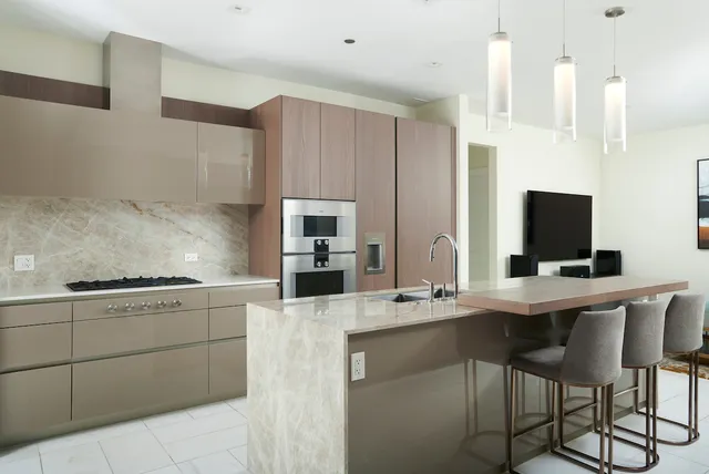 a kitchen with stainless steel appliances kitchen island granite countertop a sink and cabinets