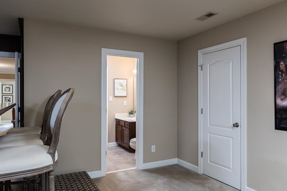8236 Clarks Branch Drive Raleigh, NC 27613 - Photo 26 of 30 There is bathroom access in this room, as well as the door on the right leads to the LARGE walk in attic storage area. Secondary staircase from this room leads directly to the kitchen. Theater Room/Bonus Space