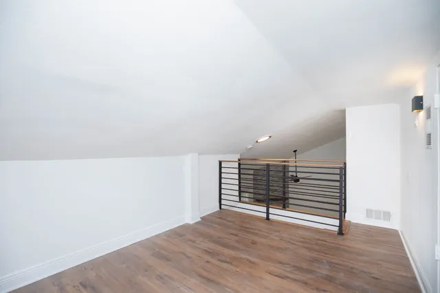 a view of wooden floor and windows in a room