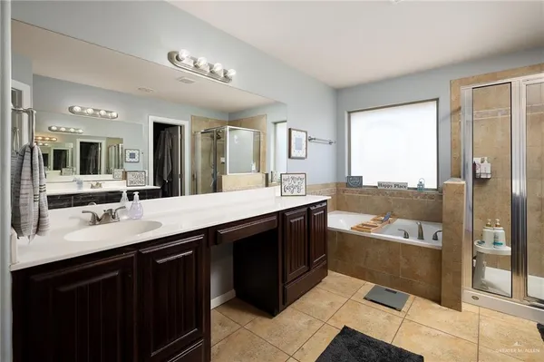 a large bathroom with a large tub shower and sink