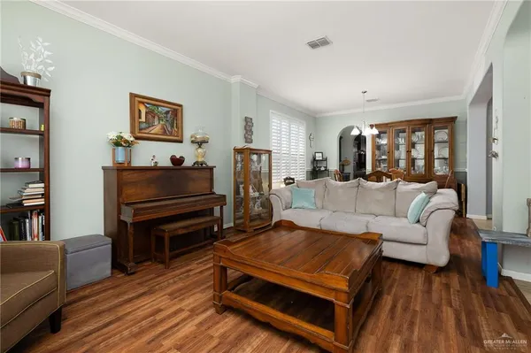 a living room with furniture and a piano