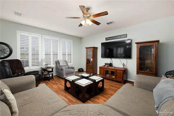 a living room with furniture and a flat screen tv