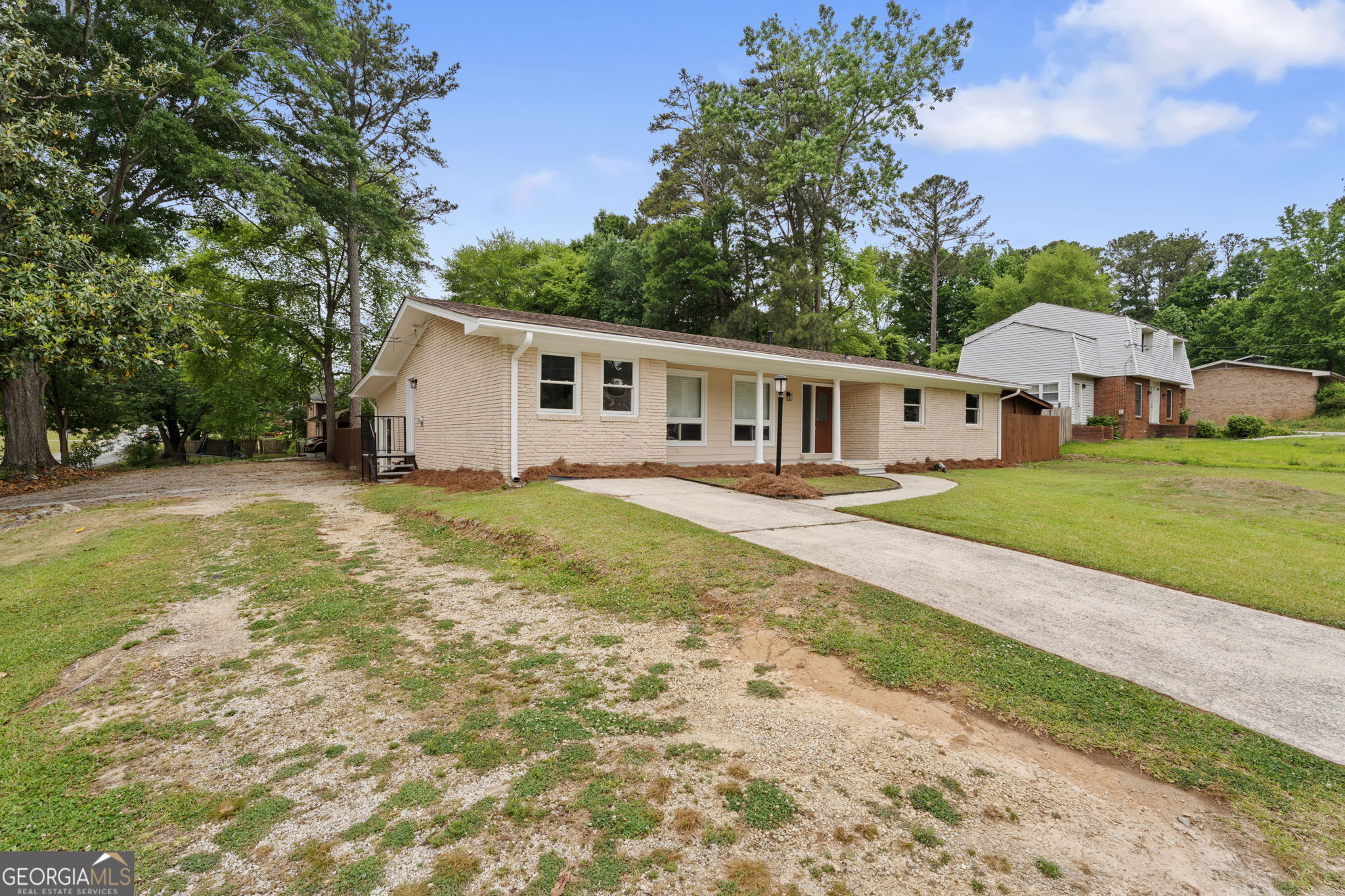 6463 Maddox Road Morrow, GA 30260 - Photo 42 of 46 a view of a house with a yard and palm trees